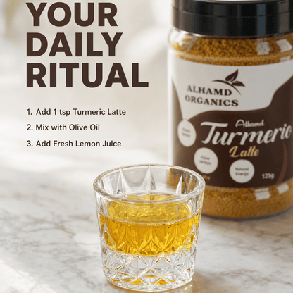 Turmeric latte with a jar of Alhamd Organics Turmeric Latte on a marble surface.