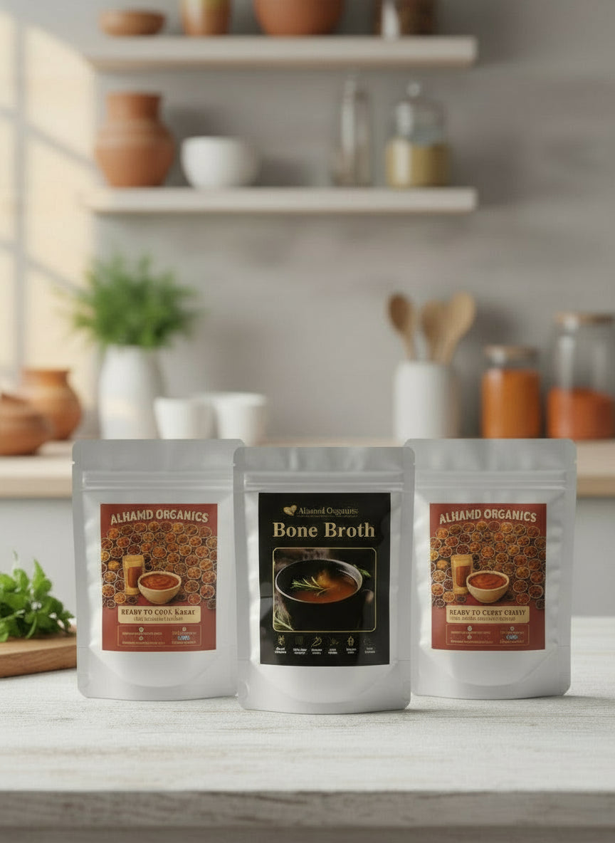 Three packages of Almond Organics bone broth on a kitchen counter with shelves in the background.